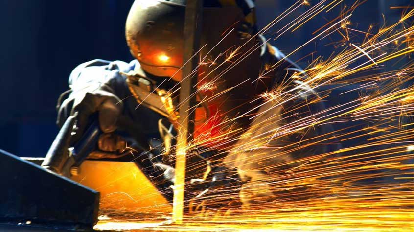 An individual welding metal to greater support the pipelines.
