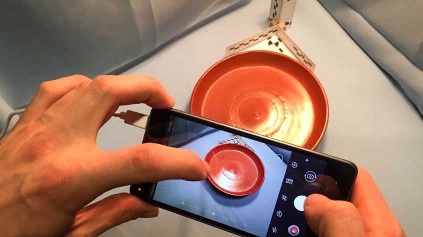 Picture being taken of a bowl using an iphone.