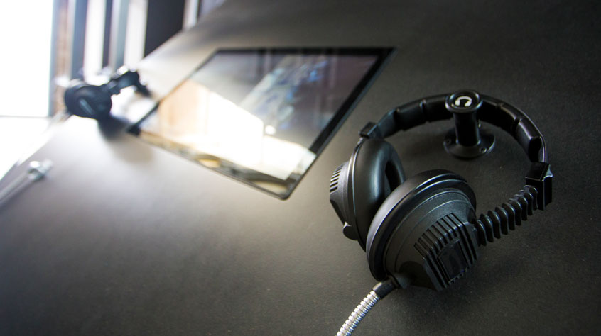 Headphones attached to a screen for an exhibition