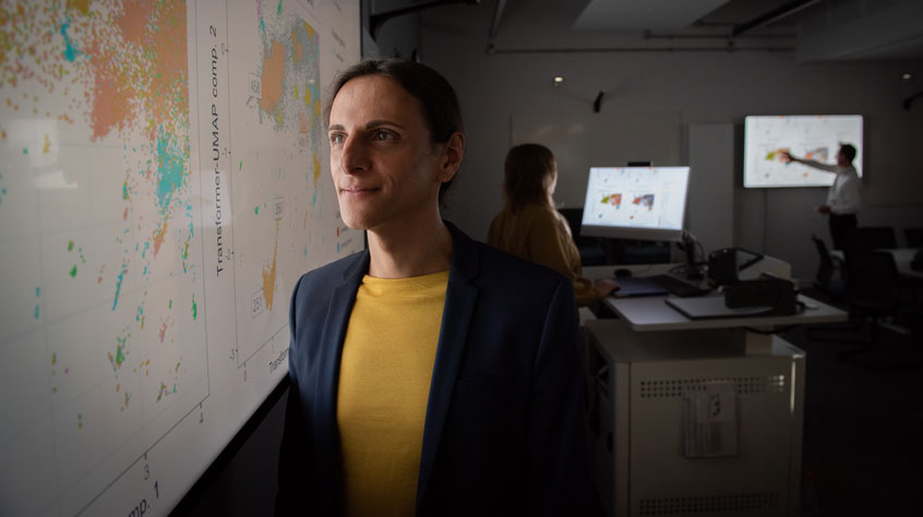 Person looking at a large digital map on a wall
