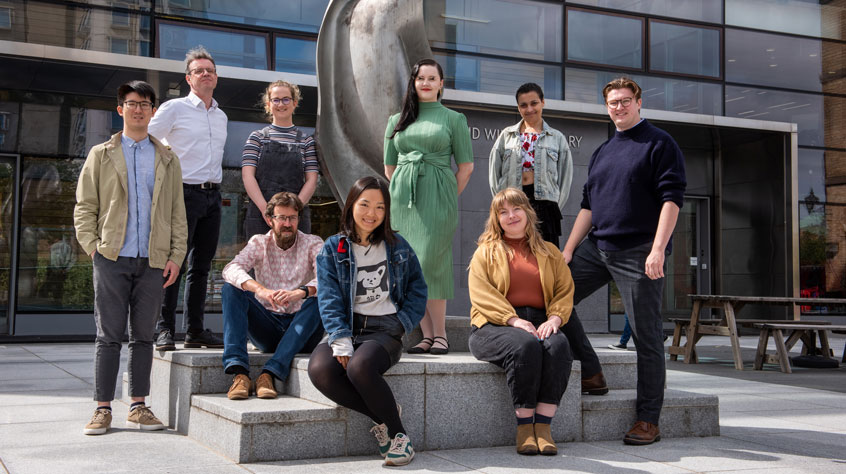 People from the Institute of Digital Culture stood together outside the David Wilson Library on the Leicester campus