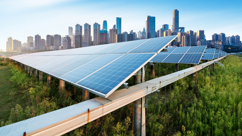 Solar panels with a sprawling city behind them