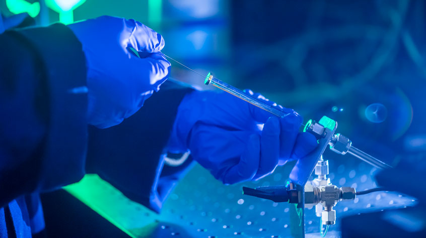 Person injecting dye into a machine