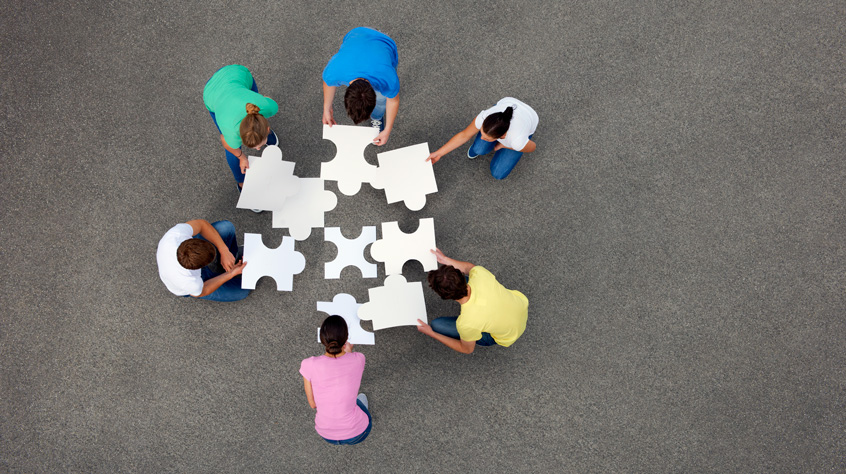 People putting together jigsaw puzzle