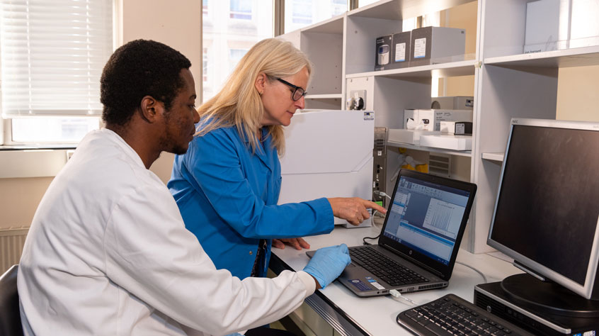 Two people in a lab looking at a computer screen