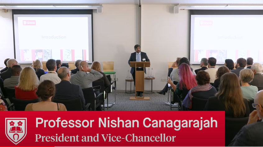 Professor Nishan Canagarajah speaking to a room full of people at the research institutes launch