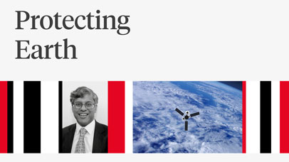 John Remedios next to a picture of a satellite in space