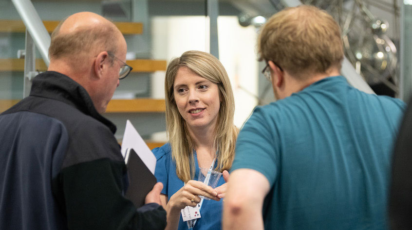 Members of staff talking to each other in a lab.