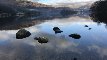 Rocks protruding from a large lake