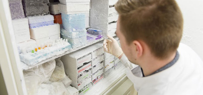 A man taking things from a medical freezer