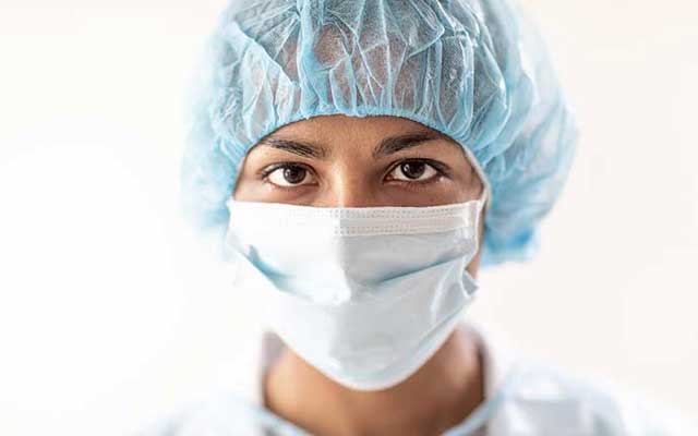 Woman wearing a hairnet and mask