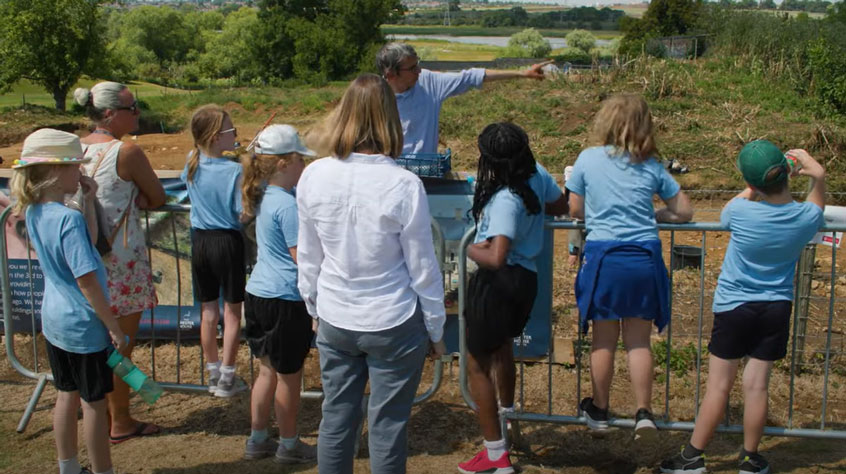 Children looking over an archaeological site