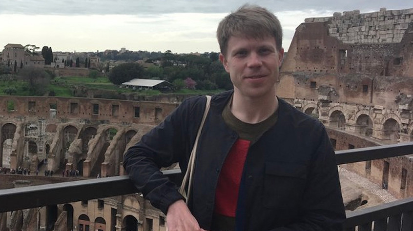 Man standing a top of a colisseum type arena that's being excavated
