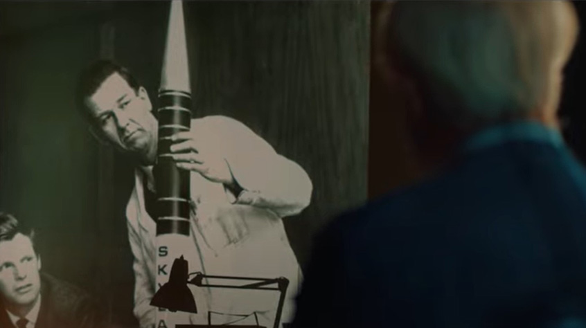 Professor Ken Pounds looks at archival photos of himself, in his youth looking at a model rocket