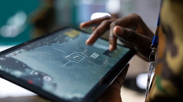 Man tapping on a large tablet