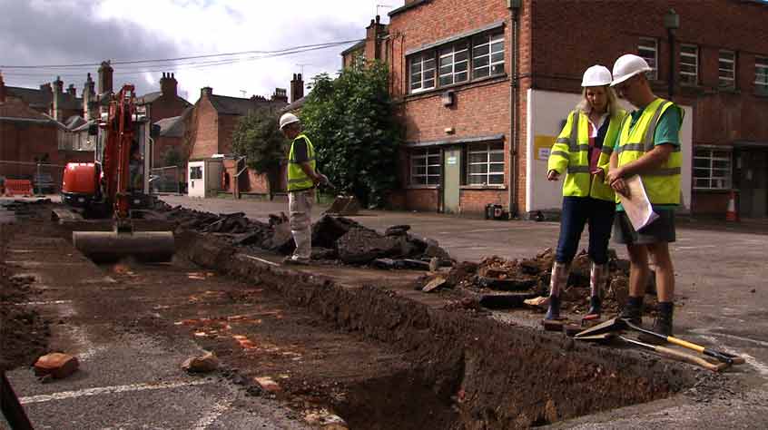 Archaeologists remove the car park and the remains of Victorian buildings with a digger to reach the medieval archaeology beneath.