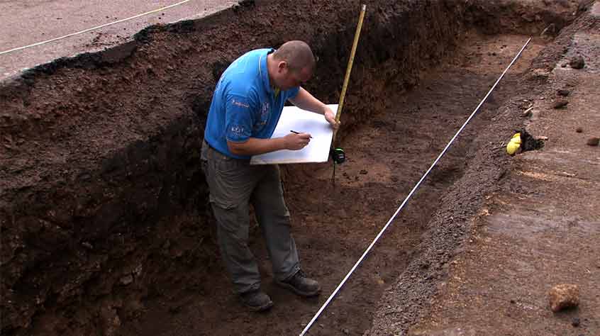 Archaeologist Martin Henson carefully plans and records the medieval deposits in Trench 2.