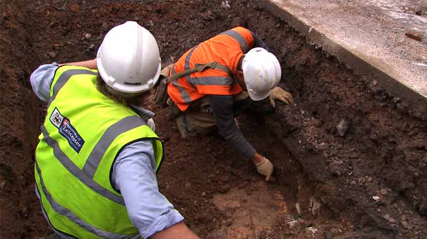 Archaeologists find an area of paving made from medieval tiles as they begin to dig Trench 3 (I).