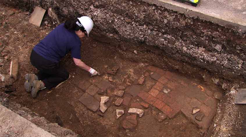 Kim Sidwell uncovers paving (I) that is made from re-used medieval floor tiles and might be part of a path in Robert Herrick’s garden.