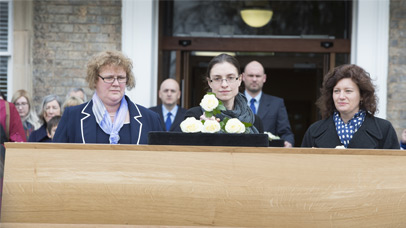 Dr Jo Appleby laying a white rose on King Richard III's coffin at the University of Leicester