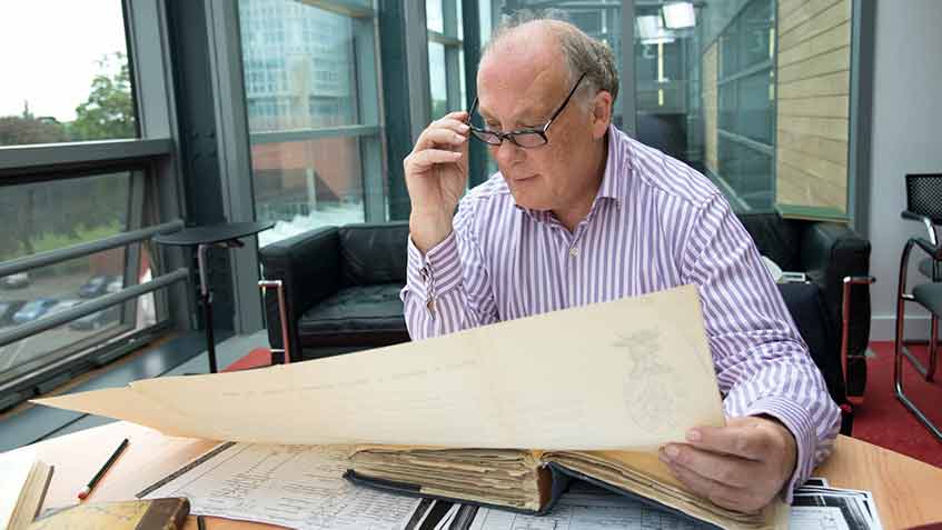 Professor Kevin Schurer looking at historical records