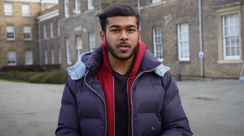 Student facing camera introducing video about applications