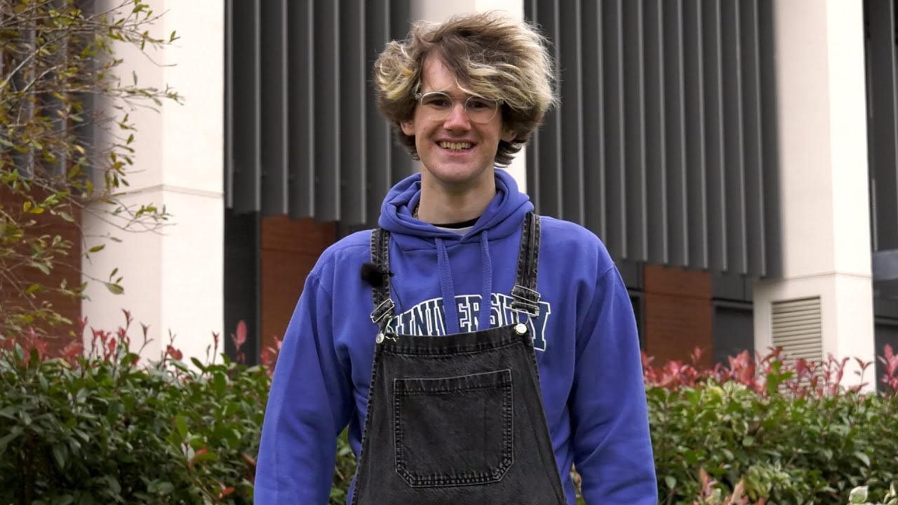 A still from the virtual campus tour, showing a smiling student ambassador hosting the tour.