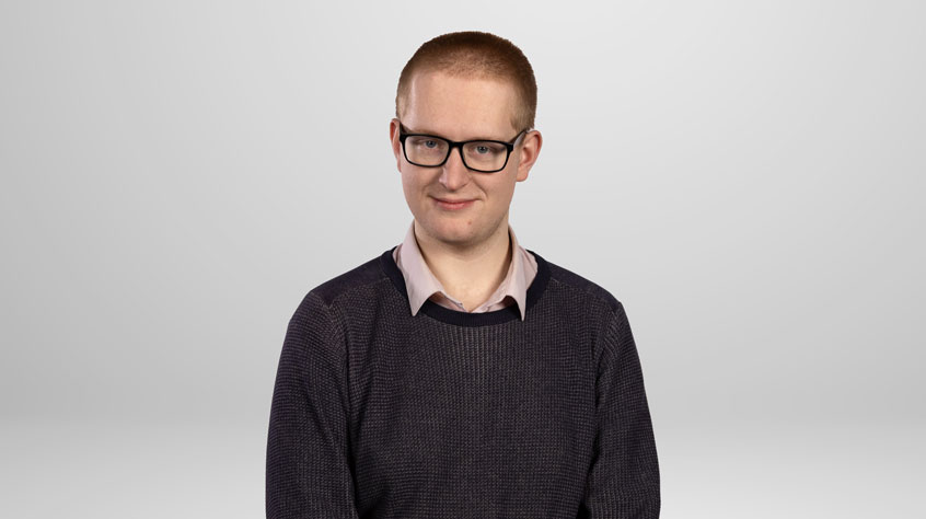 Student Charlie posing for a photo in a studio