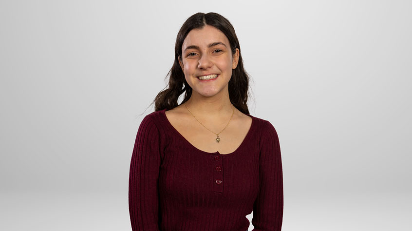 Student Charlotte posing for a photo in a studio