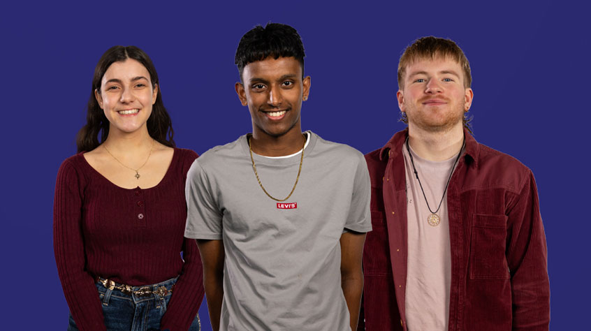 Three students looking into the camera, with a dark blue background behind them.