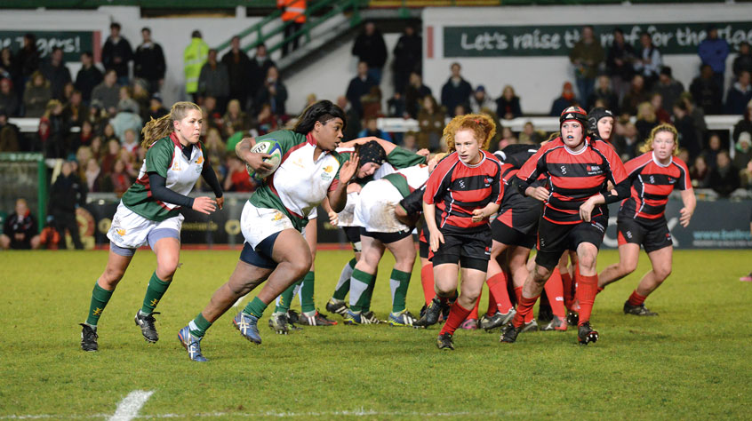 Two women's Rubgy teams in the middle of a game