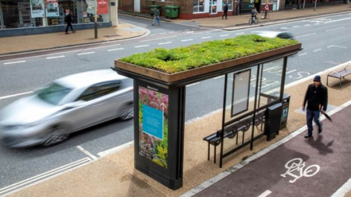 Bus stop with a grass top.