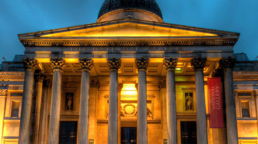 Historic building, lit up with orange lighting.