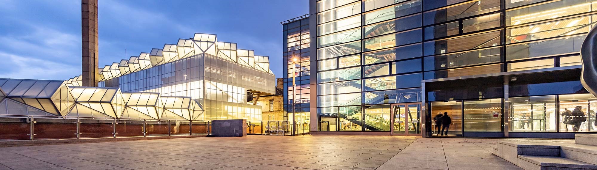 David Wilson Library with the lights on in the building at night