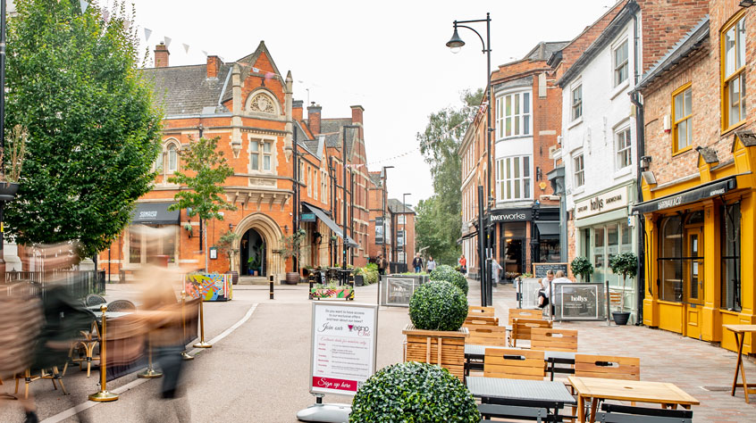 Leicester city centre street with tables outside a cafe