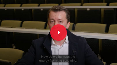 Lecturer in an empty lecture theatre being interviewed