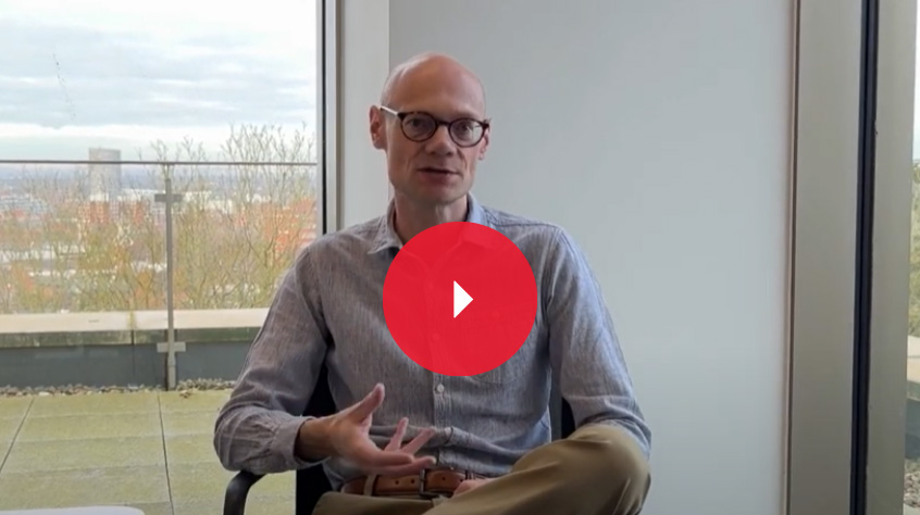 Dr Ben Parsons sat on a chair, with a window over his right shoulder, speaking directly to the camera