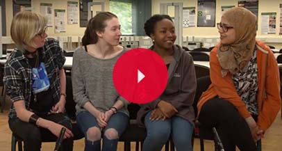 Four students sitting together talking