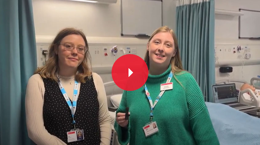 Two women in a hospital setting looking at the camera