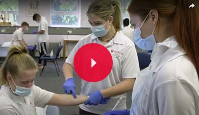 Physio students treating a patient.