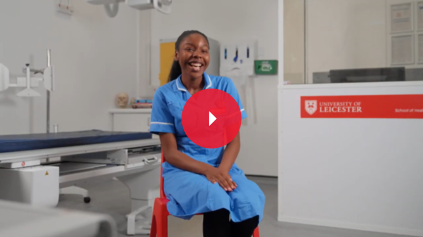A female diagnostic radiography student in a blue uniform seated in a hospital-resembling room, talking about her studies.