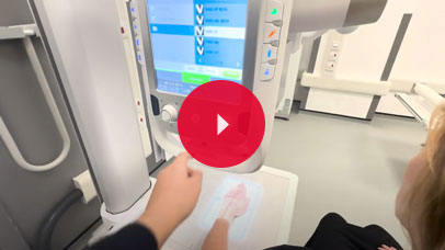 Student using an x-ray machine on a patient