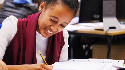Woman smiling and writing something down