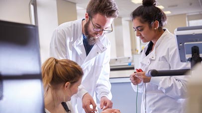 People in lab coats talking