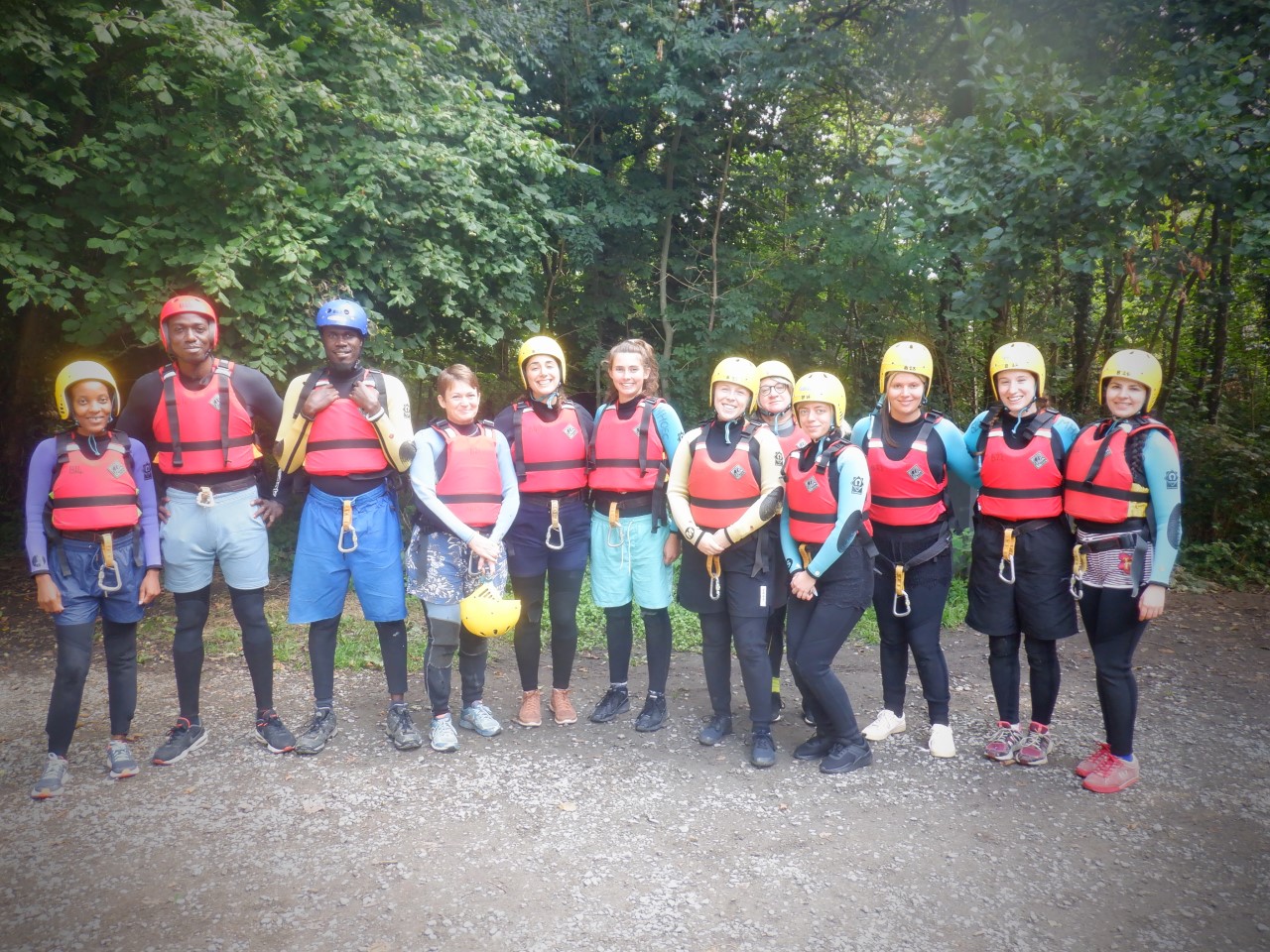 A group of WTDTP students wearing safety helmets and life jackets on a cohort building residential