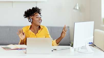 Women at desk wearing headphones and smiling