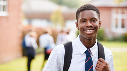 Student in a school uniform, smiling at the camera.