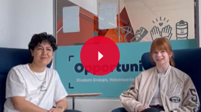 Two students sitting on comfy chairs and looking into the camera.