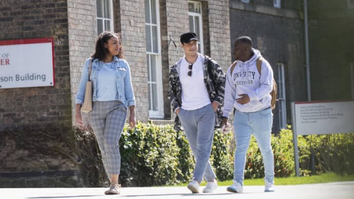Three students walking on campus