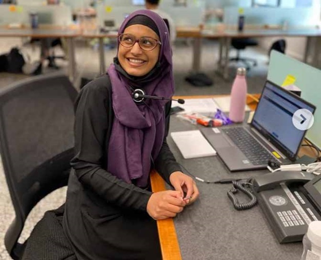 Azza BA English student sat at a desk